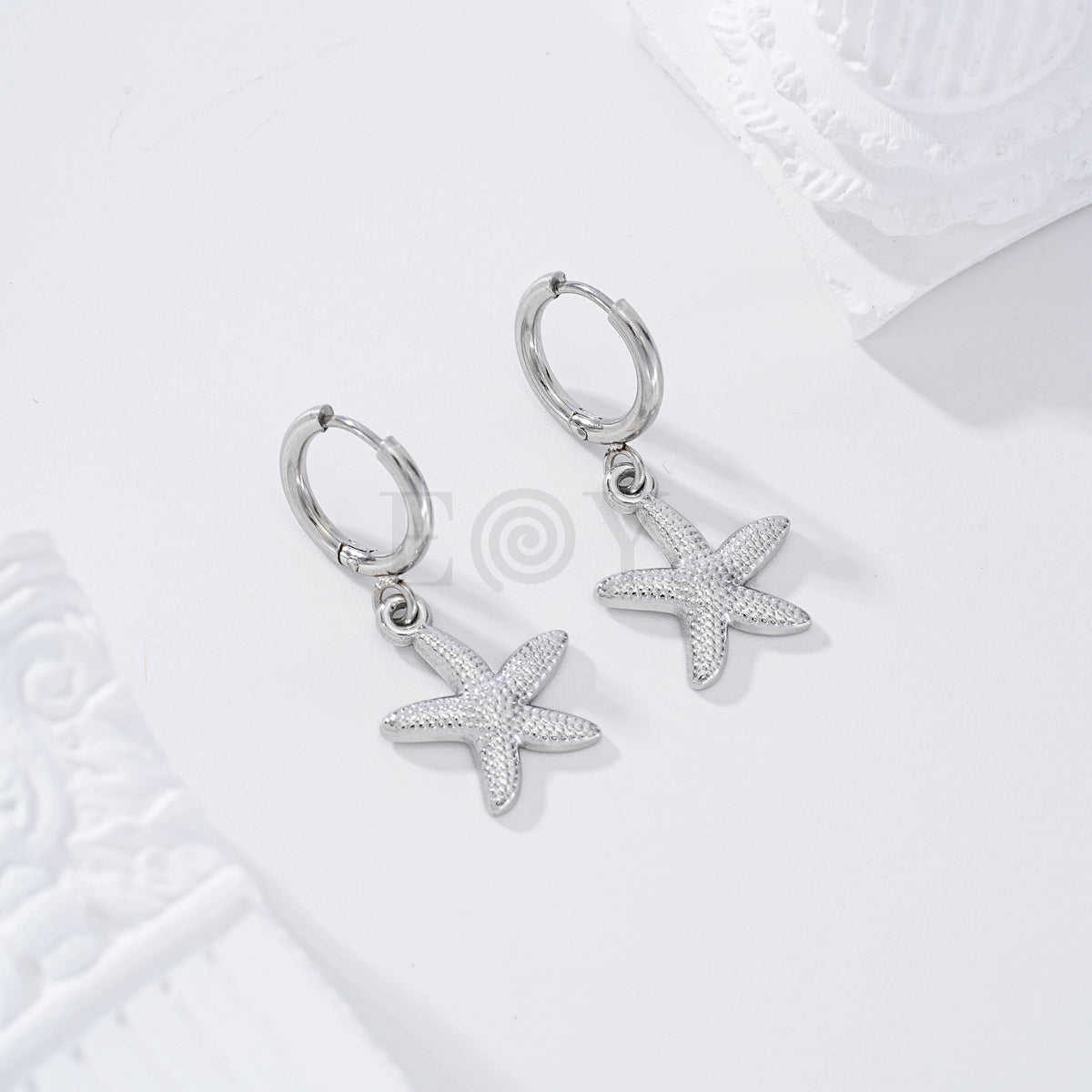 Pendientes de aro estrella de mar relieve acero