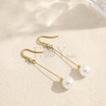 Pendientes largos con barra y cuenta blanca