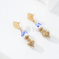 Pendientes chapa trébol con bola blanca y detalle dorado
