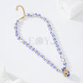Collar con bolas con flores azules y detalle con piedras