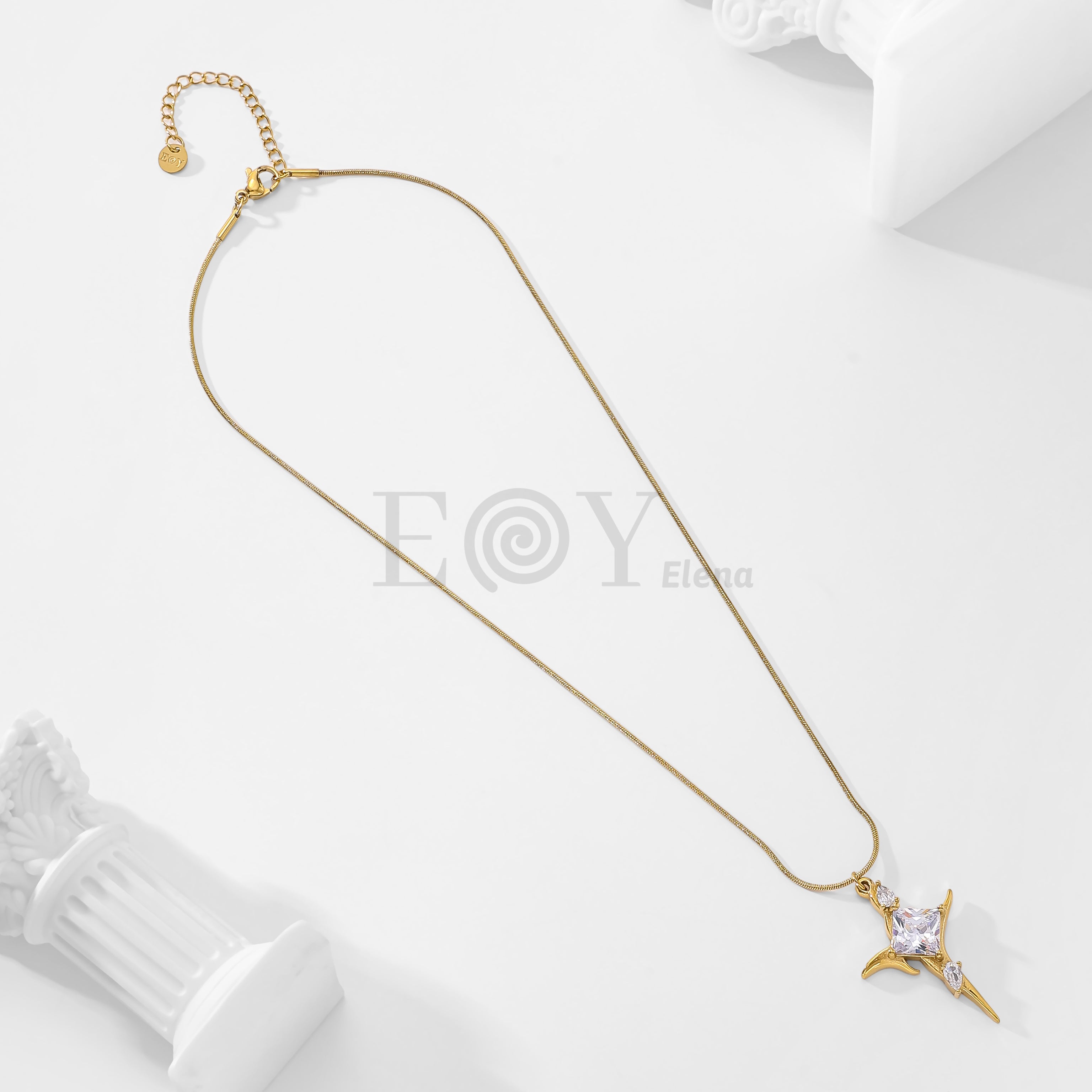 Collar cruz con piedra blanca