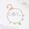 Pulsera de cadena dorada con colgantes de estrella de mar, delfines y circonitas