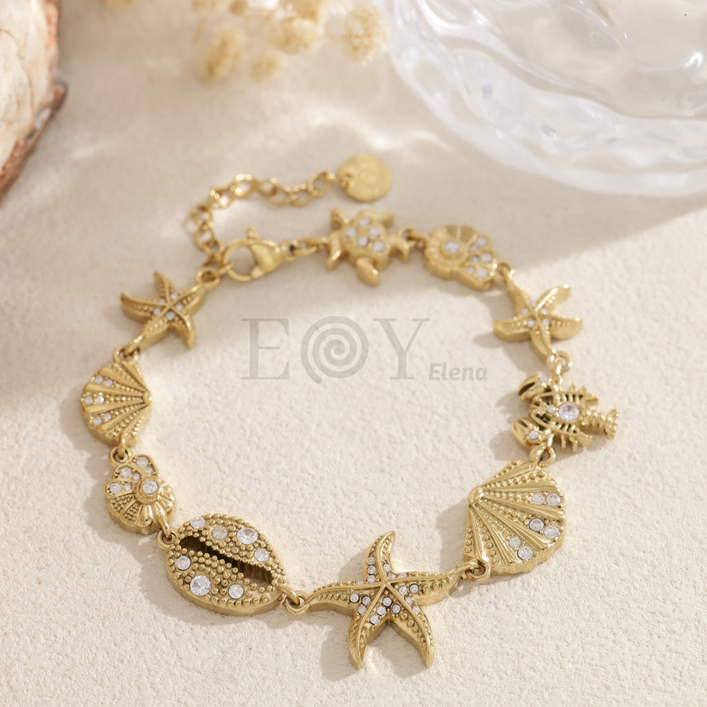 Pulsera marina dorada con charms