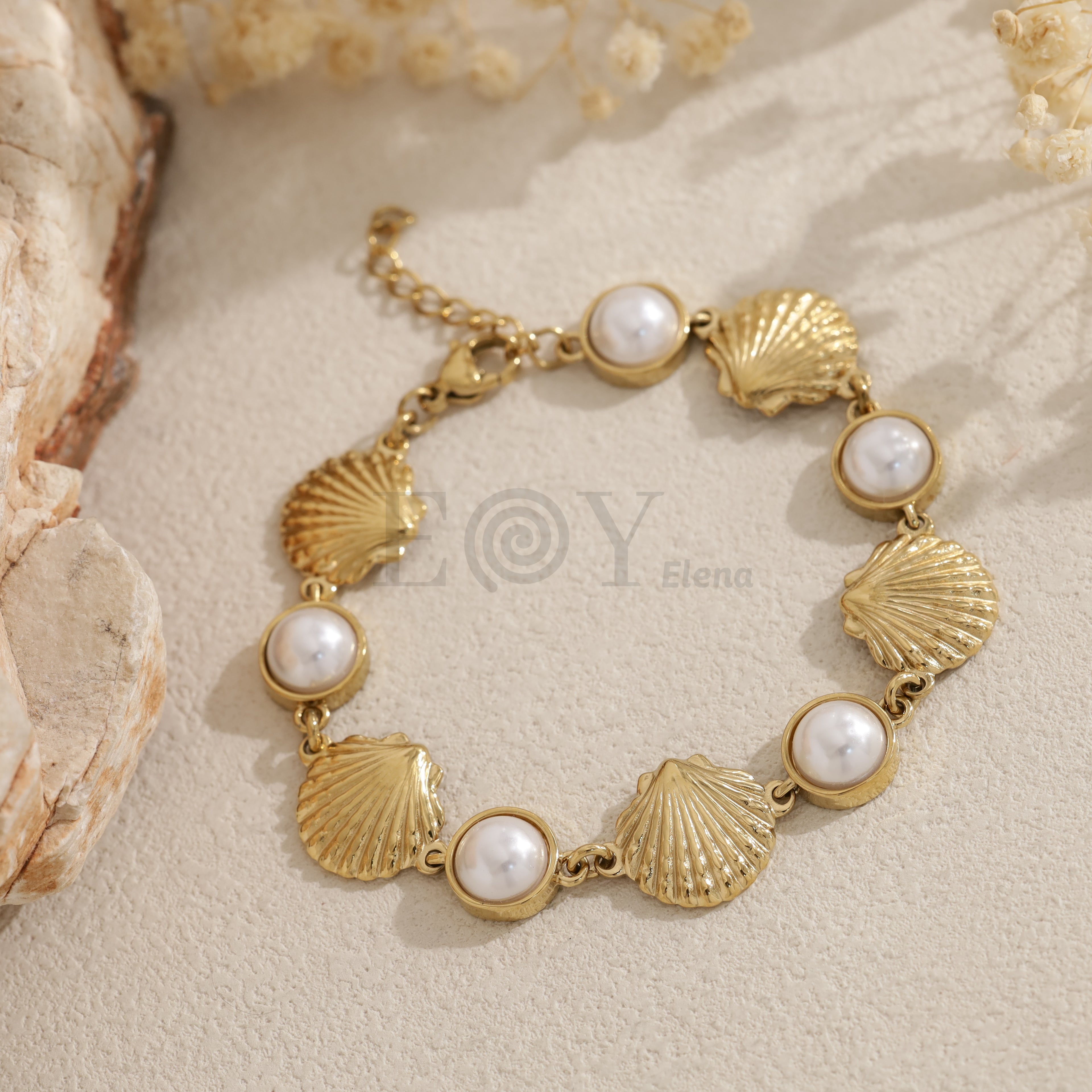 Pulsera dorada con conchas marinas y perlas blancas