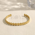 Brazalete abierto con discos grabados