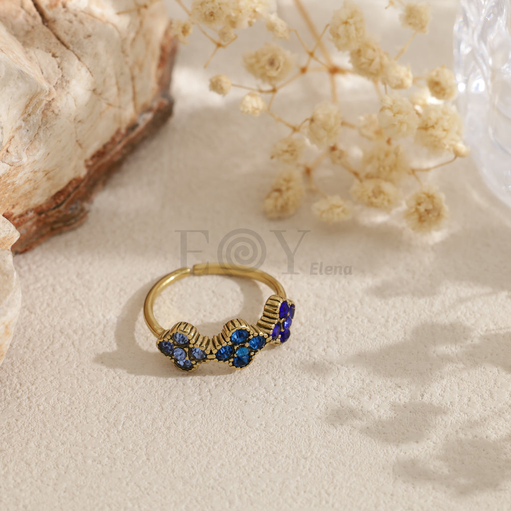 Anillo abierto dorado con circonitas de colores